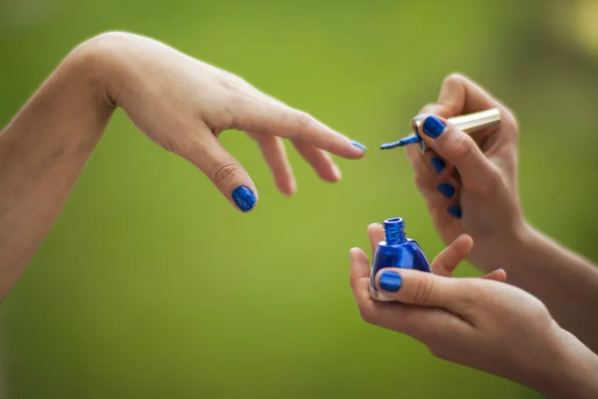 A manicure in progress — polish being applied